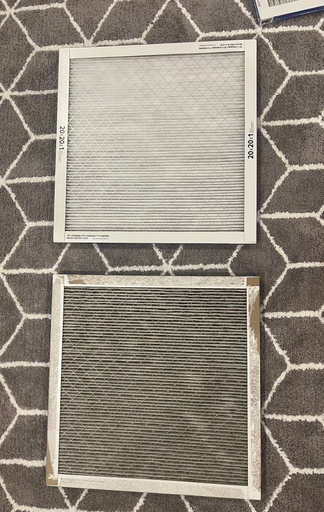 Two furnace filters pictured. The top is new and bright white. The bottom is used and grimy and black. 