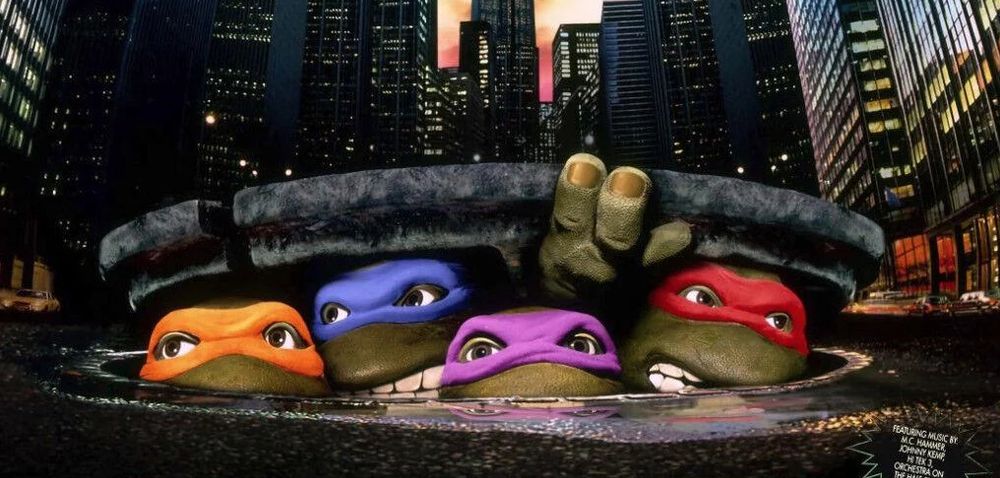 Poster from the 90s Ninja Turtles live action film. Turtles poking their heads out of a man-hole. 
