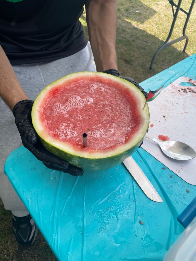 Half of a hollowed-out watermelon, filled with its own juice blended that’s been blended with ice.