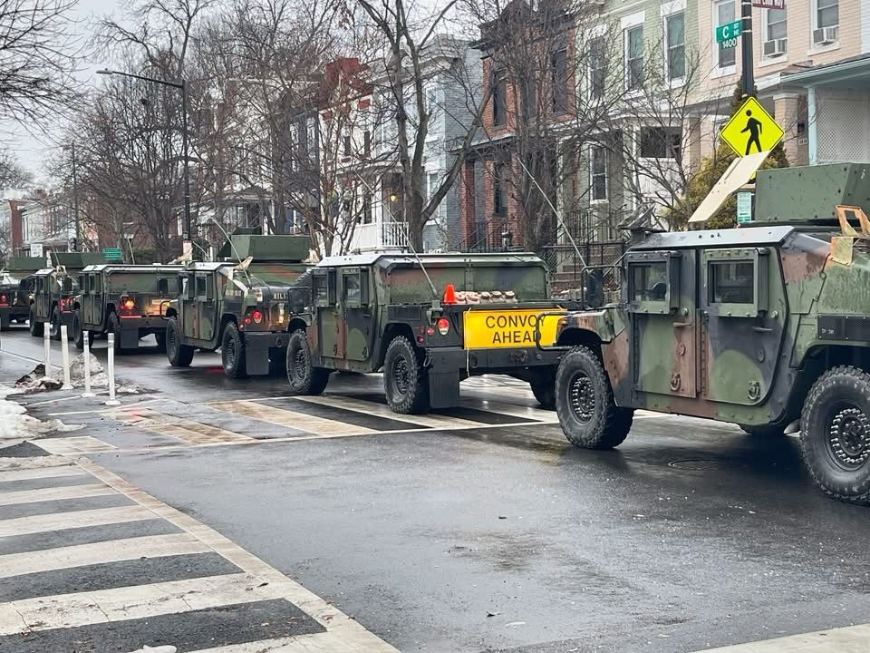 Army Humvees on public street in Washington DC. Sign on one vehicle reads “Convoy Ahead”