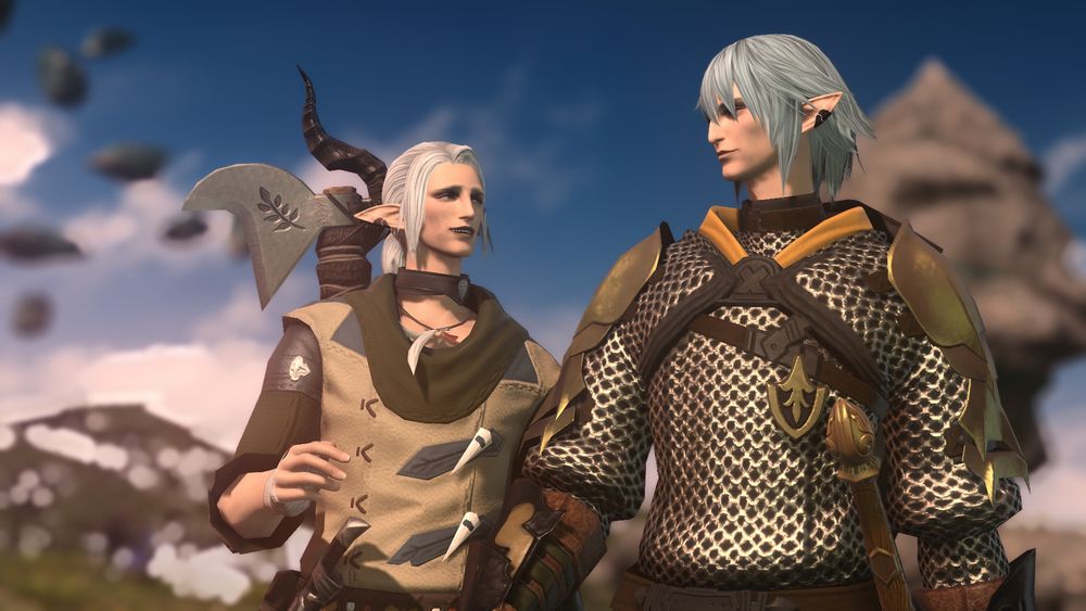 Closer shot of the two from the waist up.