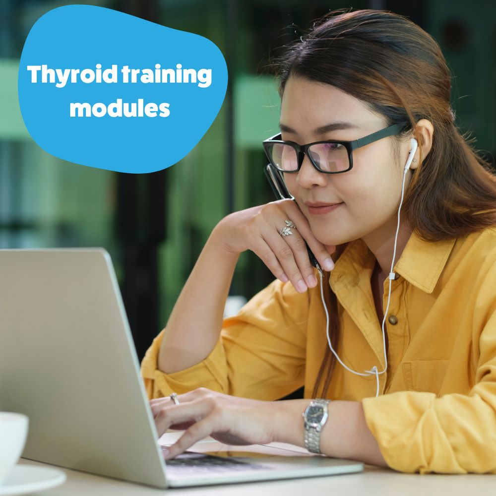 Young woman is sitting at her laptop wearing earphones. Caption reads: 'Thyroid training modules'