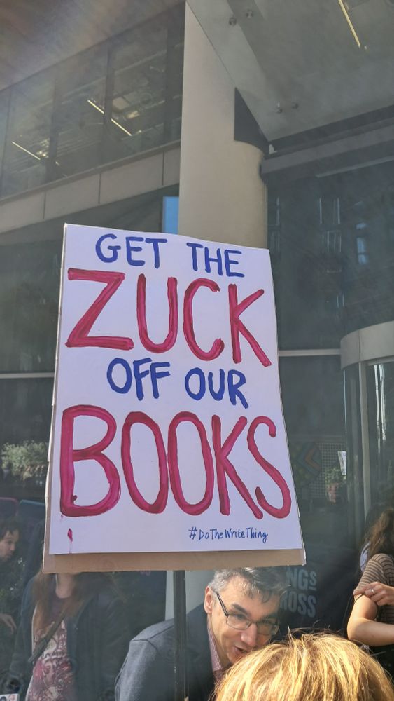 A sign that says "Get the Zuck off our books"
