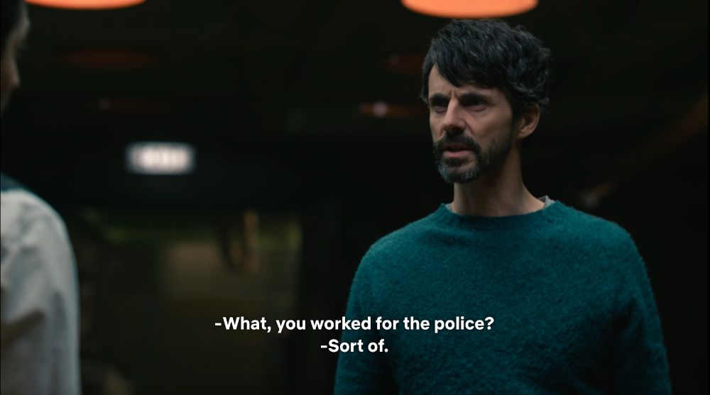 shot of Morck - i.e. Matthew Goode wearing a dark greenish-blue sweater with a mop of salt & pepper hair and facial hair - looking perplexed, brow furrowed. he's saying, 