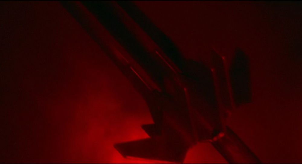giant triple-bladed sword that looks like three swords glued together side-by-side, arranged diagonally across the frame, with sick misty red backlighting 