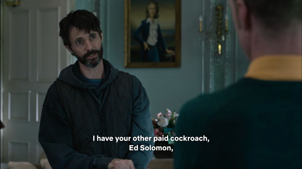 shot of bearded Matthew Goode wearing a hoodie in a ritzy country club, caption reads, 