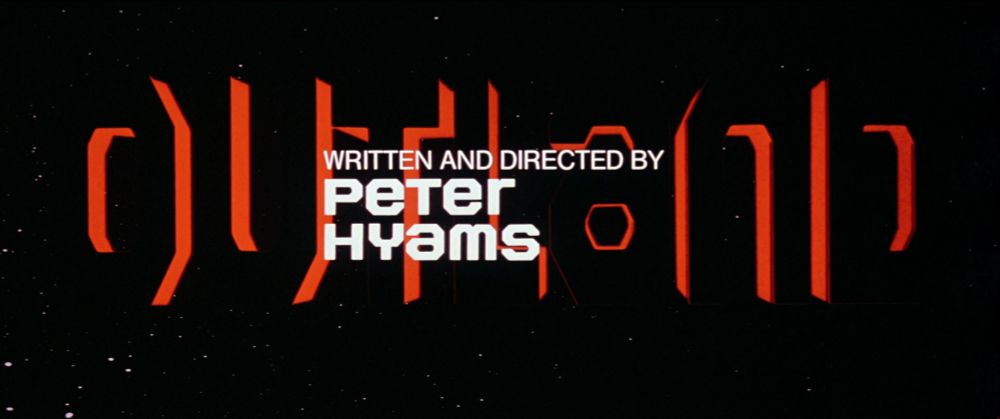 title card for Outland that reads "WRITTEN AND DIRECTED BY PETER HYAMS" in white font, the silhouette of the word "OUTLAND" behind it in big black font with red border, background is pitch-black space with tiny white stars 
