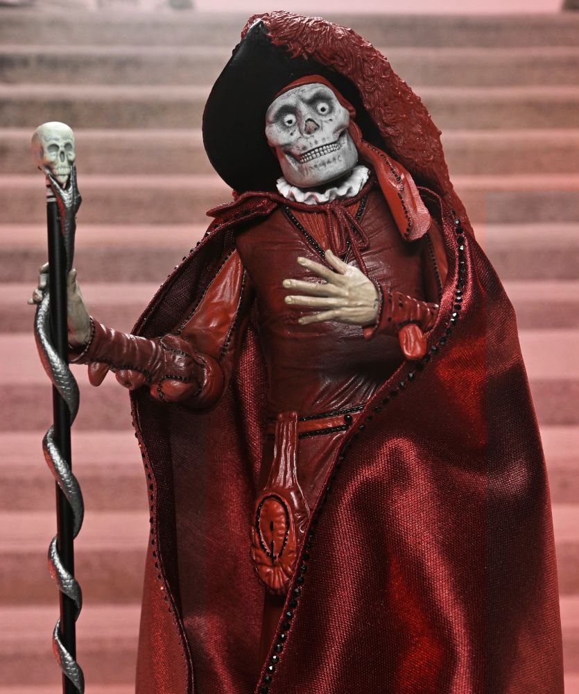 NECA's Erik/Lon Chaney action figure from The Phantom of the Opera (1925) in his Masque of the Red Death costume: a skull mask, a dark red/burgundy cloak, large brim hat with feather, and skull staff with a silver snake wrapped around it. 