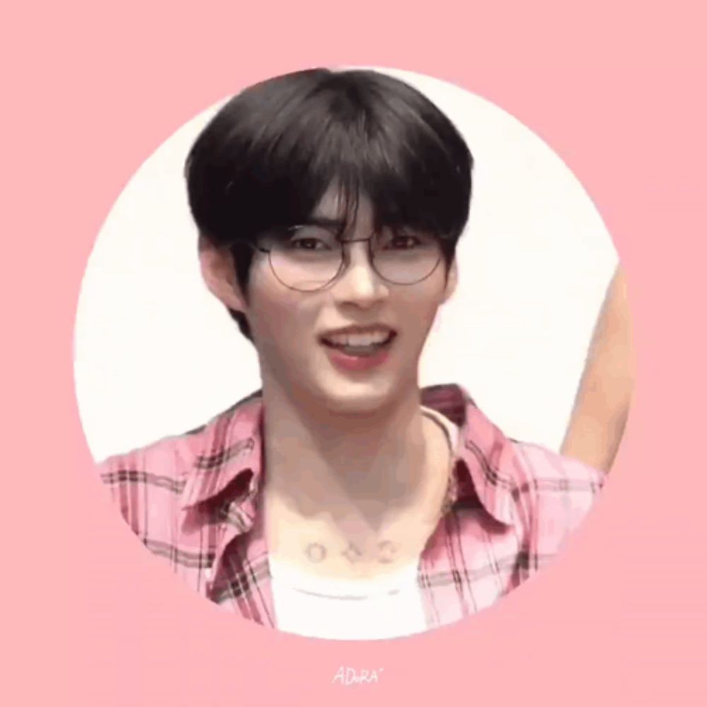 a young man wearing glasses and a pink plaid shirt is smiling in a circle .