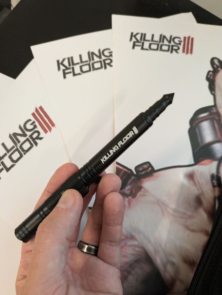 An emergency pen, made of steel and with a glass-breaker point