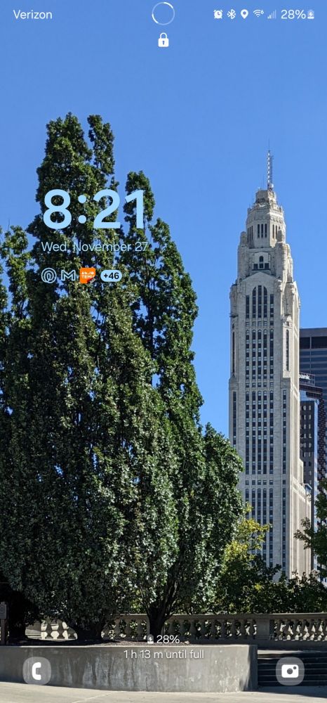cell phone lock screen featuring a large tree and the Leveque Tower in Columbus, Ohio. The time reads 8:21 and the phone appears to have 28% charge.