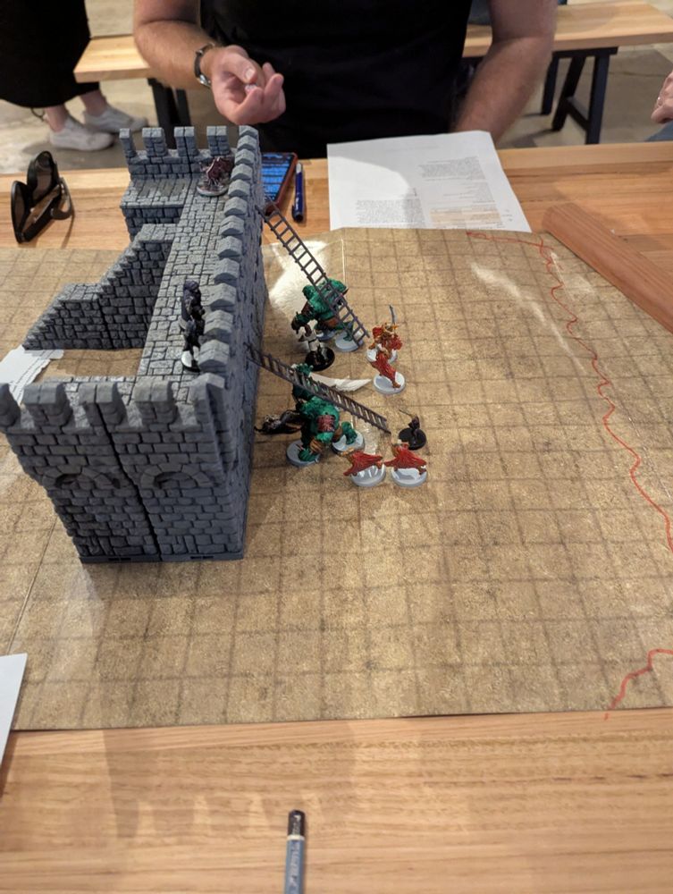 Zombie Ogres with ladders attached to their backs laying siege to a castle