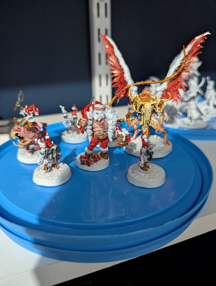 A picture of D&D minis including a Himbo Santa and Christmas goblins.