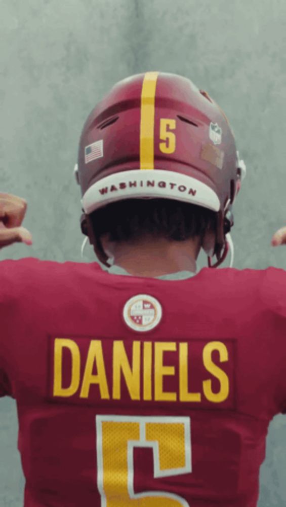 a washington football player wearing a red jersey and a helmet