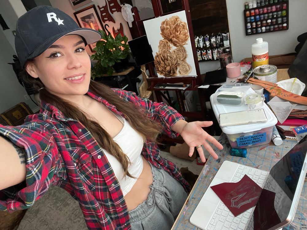 Selfie of me at my workbench wearing a plaid and my hair in bunchies