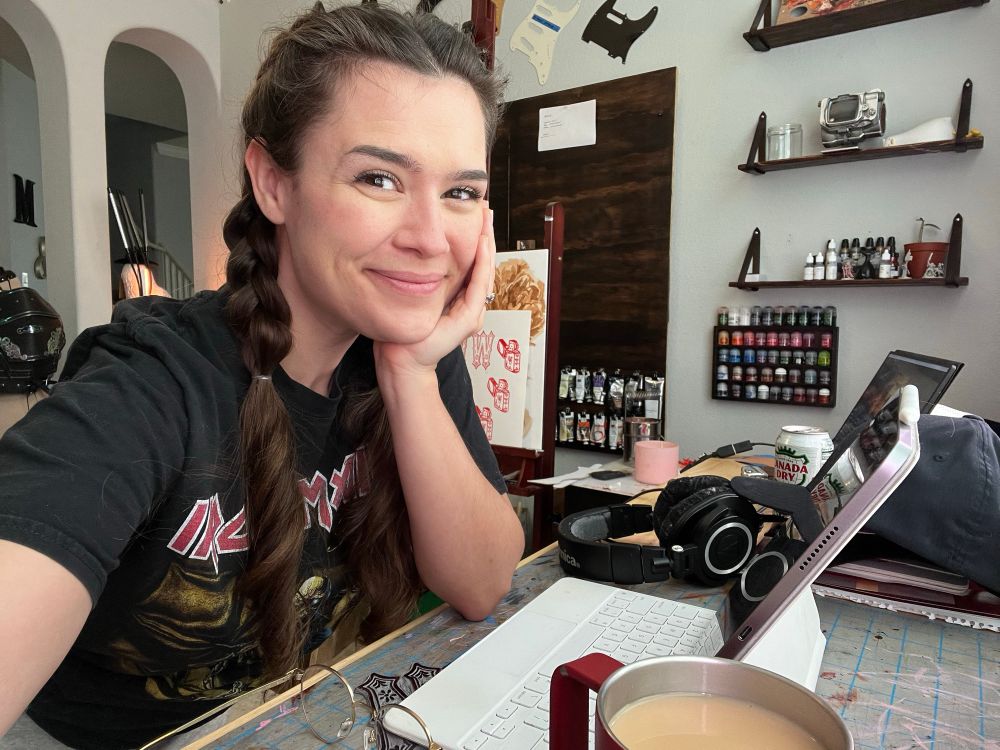 Selfie of me smiling at my messy workbench 
