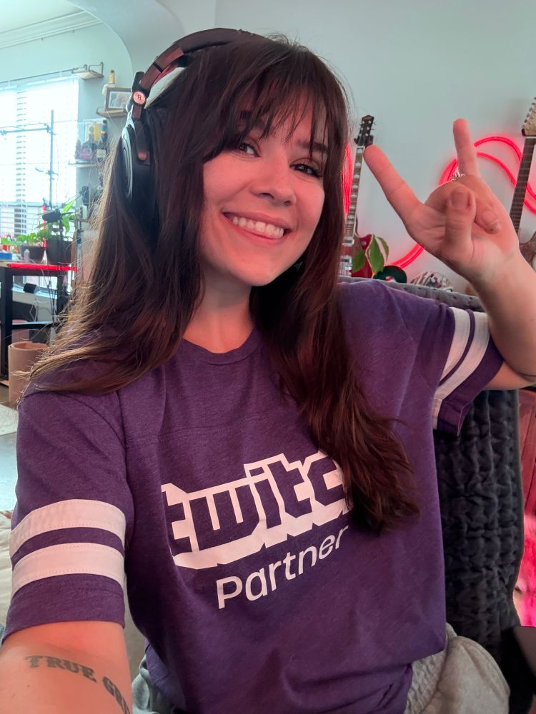 Selfie of me at my desk wearing a purple twitch shirt 