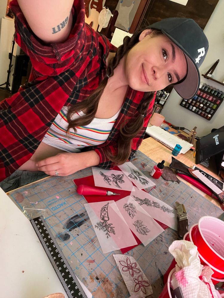 Selfie of me at my workbench with my linocutting crafts infront of me 