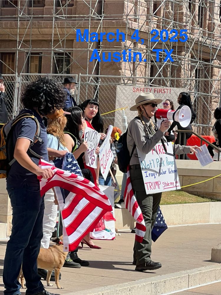 Fired park ranger using bullhorn to address crowd. 