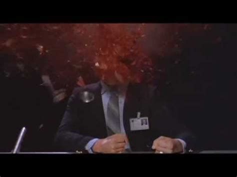A color photo of a character from the movie Scanners (1981), as his head is exploded from within.