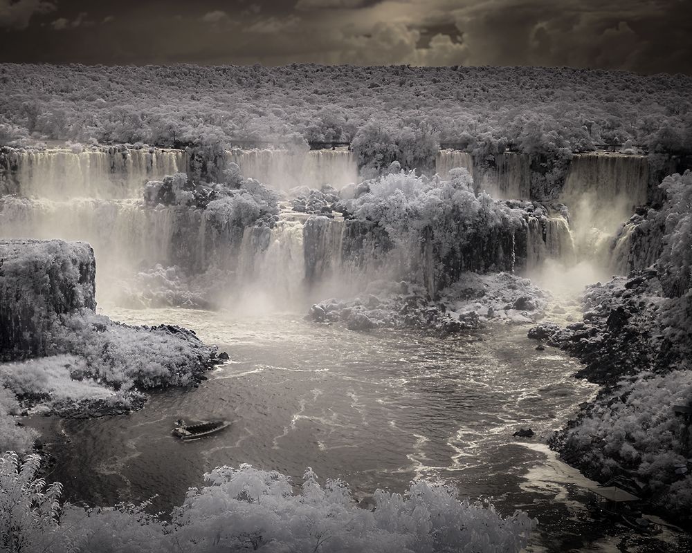 Infrared monochrome image of Iguazu Falls on the border of Argentina and Brazil. To indicate the size and scale of the falls, the lower left corner of the image shows an excursion boat approaching them.