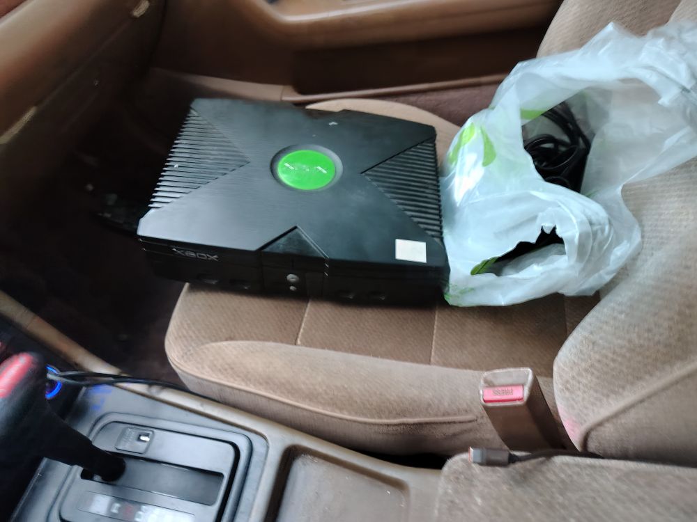 Photo of an OG Xbox sitting in my car's passenger seat