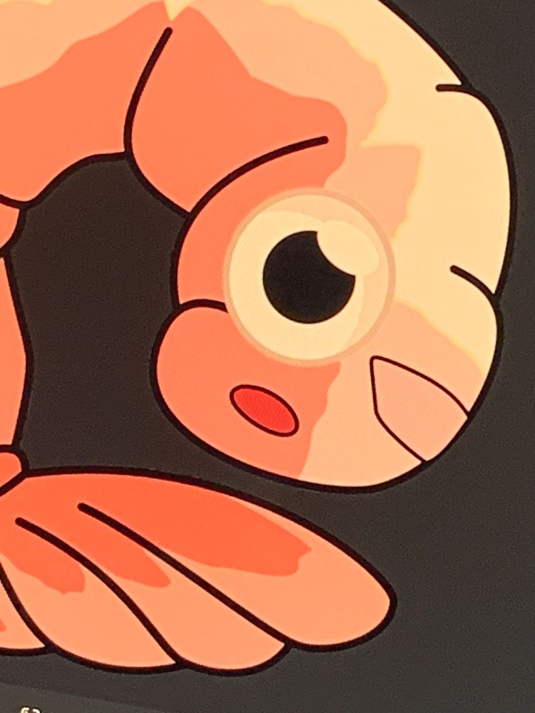 A closeup of a drawing of a cooked shrimp with googly eyes