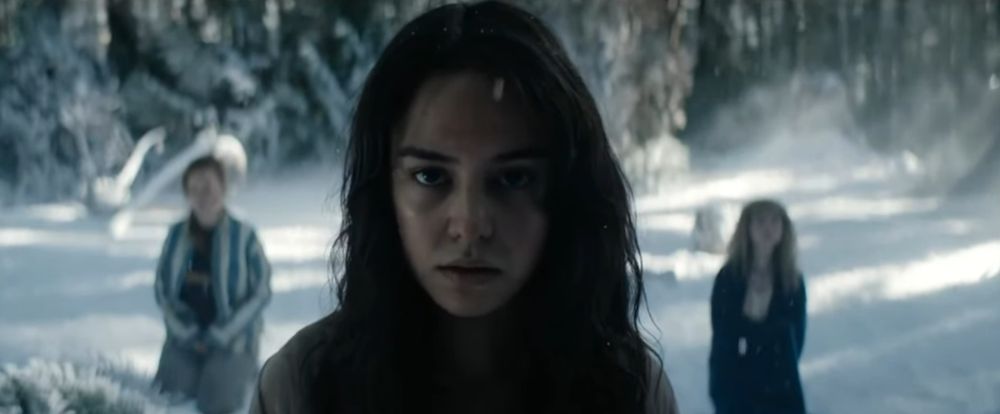 Lottie Matthews from Yellowjackets. She is dirty and grimy, and looking into the camera with a dead-pan stare.