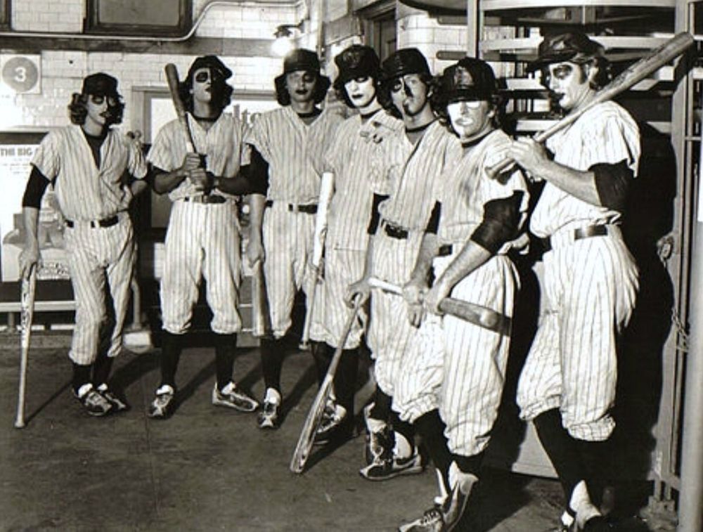 The Baseball Furies gang from "The Warriors". They dress like baseball players, paint their faces like glam rockers, and chase people around wielding baseball bats. Typical New Yorkers from the 1980s. 