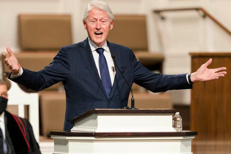 Bill Clinton bringing the word at a fune before leaving with two plates from the repast. 