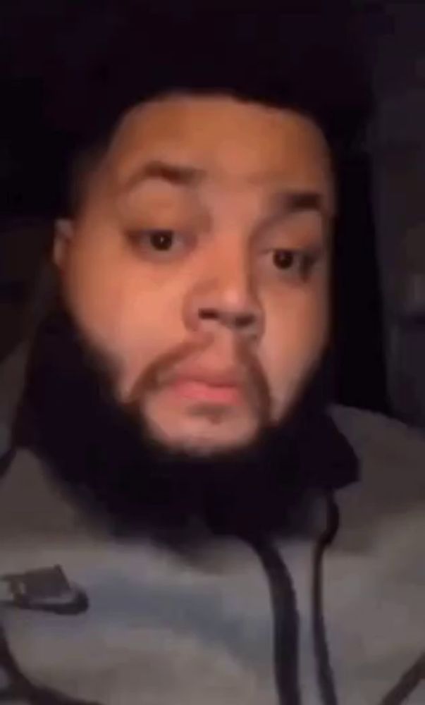 a man with a beard is making a funny face in a video .