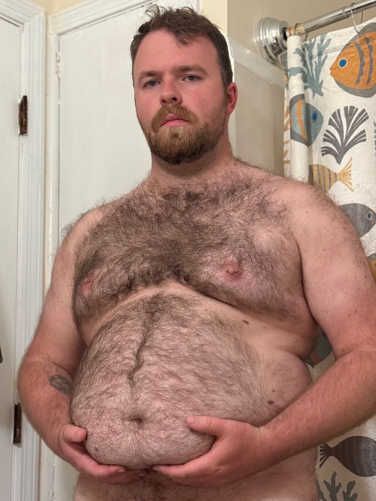 Photo of me, nude, cropped from the belly up, holding my belly.