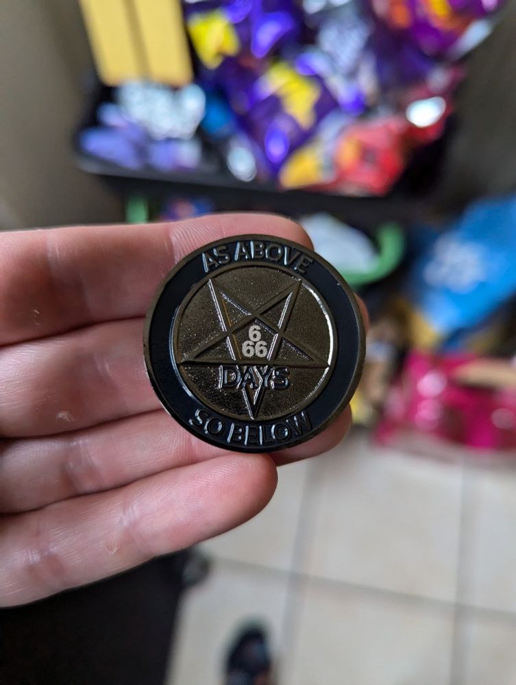 The other side of the coin. It says "As above, so below" in the centre it has a pentagram and says 666 days in the centre. Hail Satan. 