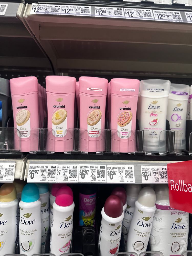 Deodorant on a shelf in a store that is a scent collaboration between Dove and Crumbl Cookies. 