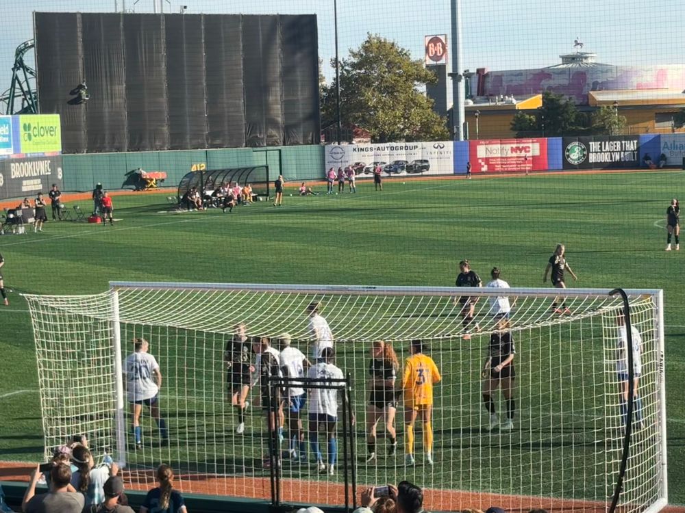 Soccer players around the goal for a corner kick