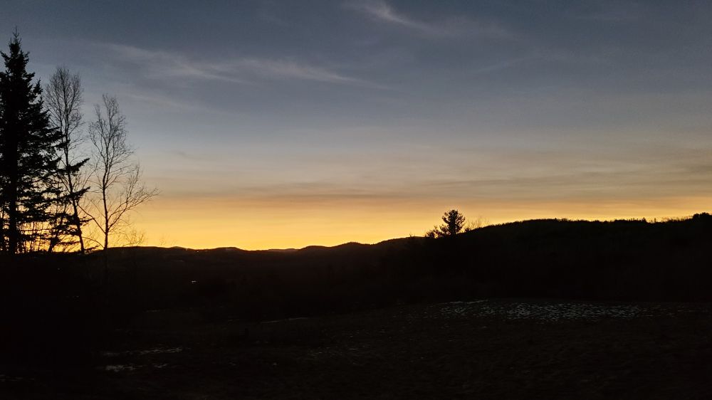 View of the horizon during a solar eclipse, where there is still sunlight in the distance.