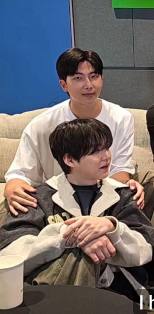 Namjoon with his hands on Yoongi’s shoulder while he’s staring at the screen. He looks protective of Yoongi.
