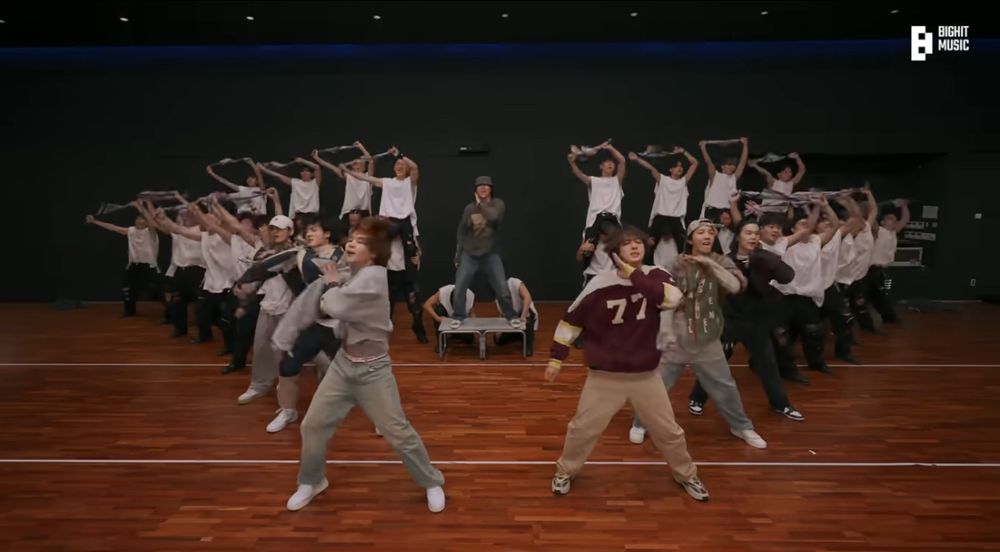 Run BTS dance practice snapshot with Namjoon at the center behind all members, hyung line is on the right with the youngest of them at the center, and maknae line on the left with the youngest of them at the center