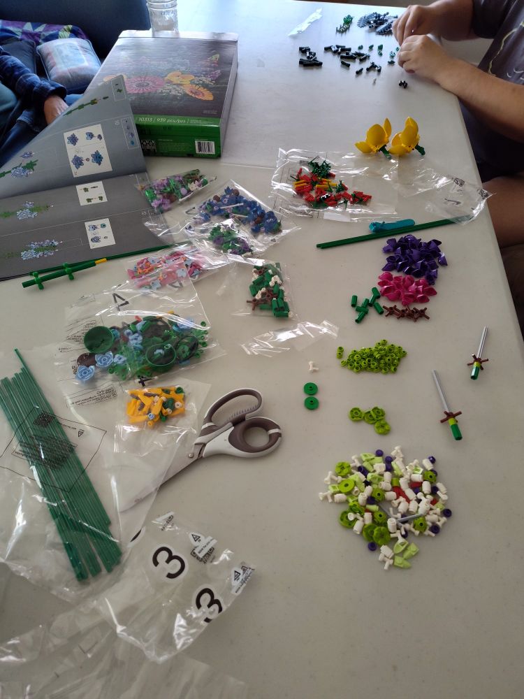 A folding table covered by various Lego parts.