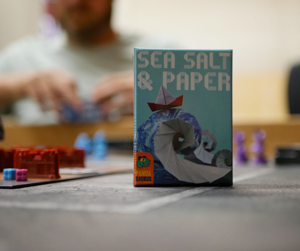 Photo of Sea Salt and Paper on a table.
