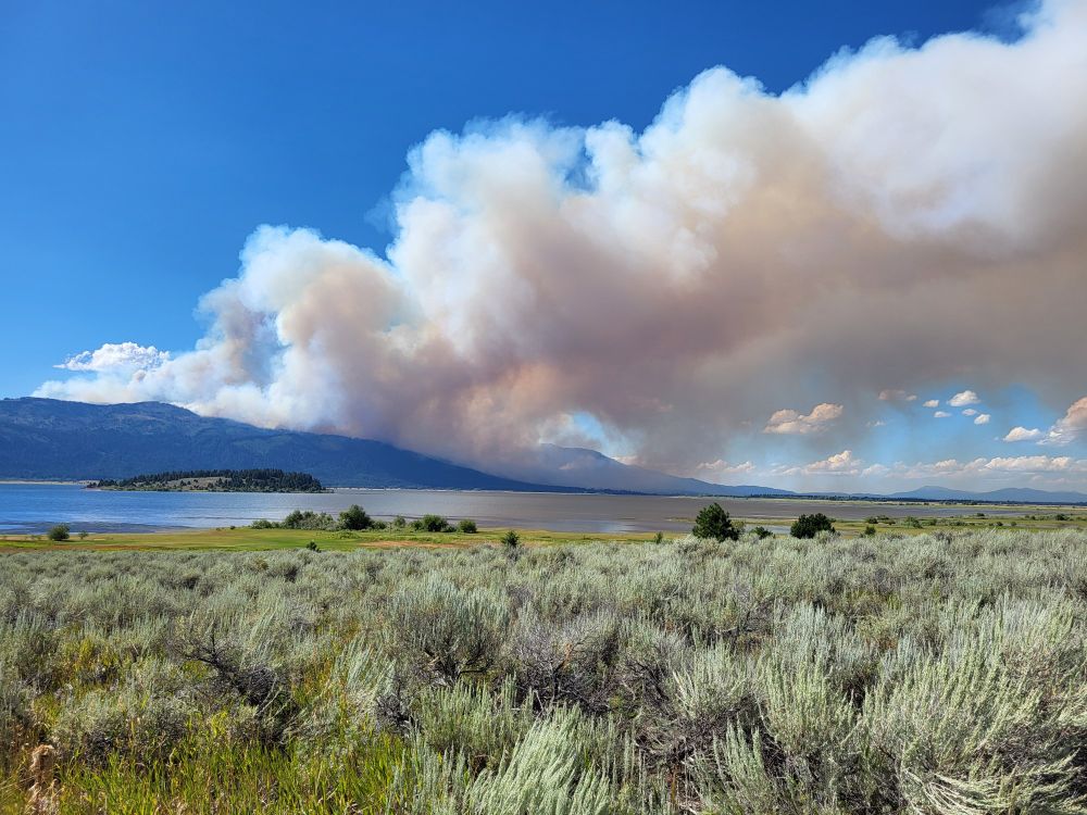The Rock Fire at 4:34pm on August 13. Sagebrush in the foreground, Cascade Lake beyond, fire on the distant mountains.