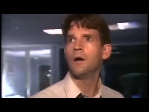 A still shot from the 1994 movie Without Warning. A brown-haired male reporter is looking offscreen with an expression of abject horror.