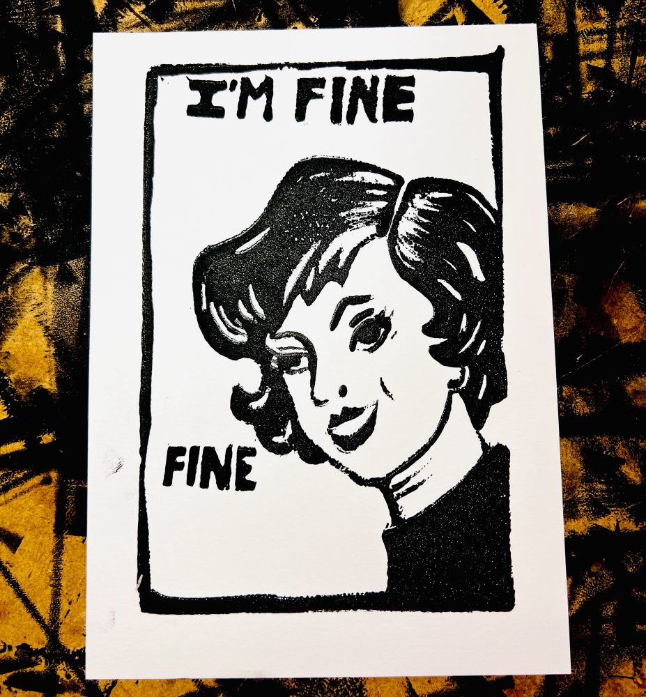 Linoleum block print of a woman with a retro flippy bob hair cut and arched eyebrows smiling. Texts says “I’m fine” and “fine”.