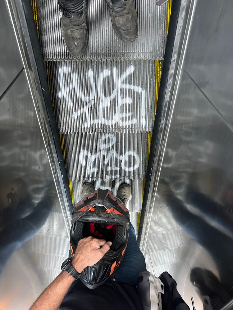 A photo taken on the escalator at the 12 St Station in Oakland, California saying “fuck ice”