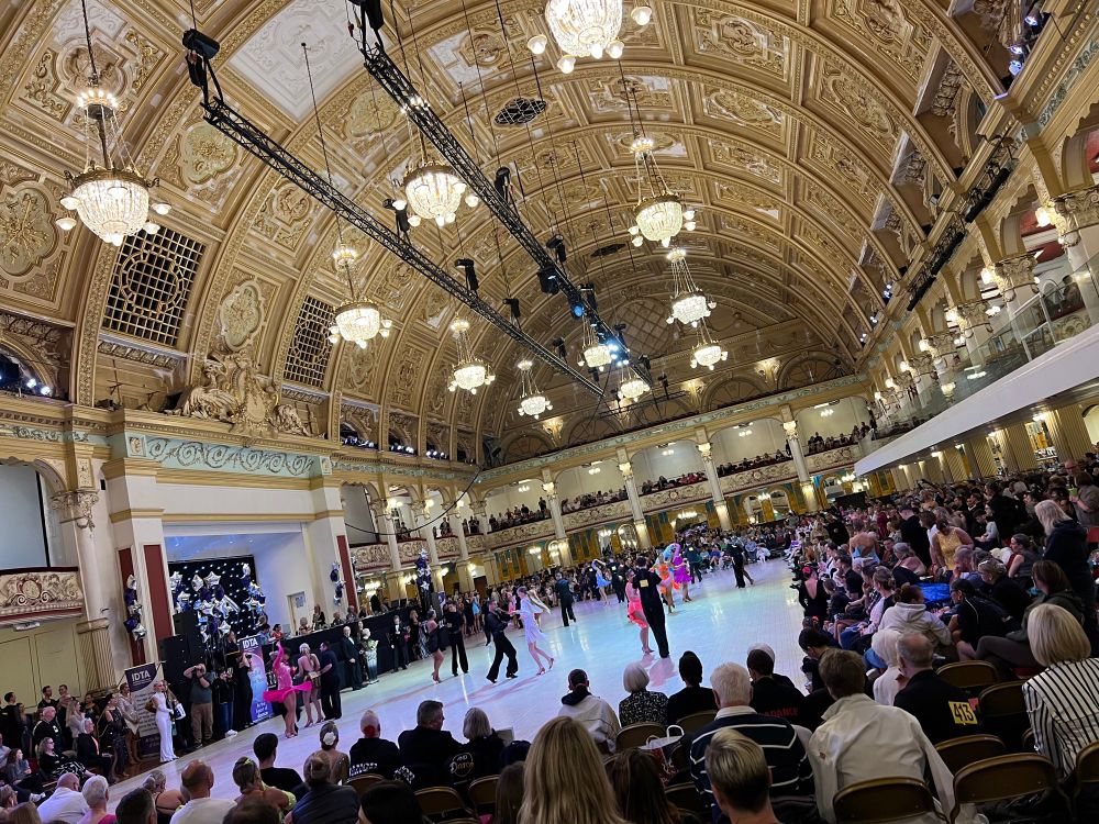 A ballroom in Blackpool with dancers on the floor and a big crowd watching 