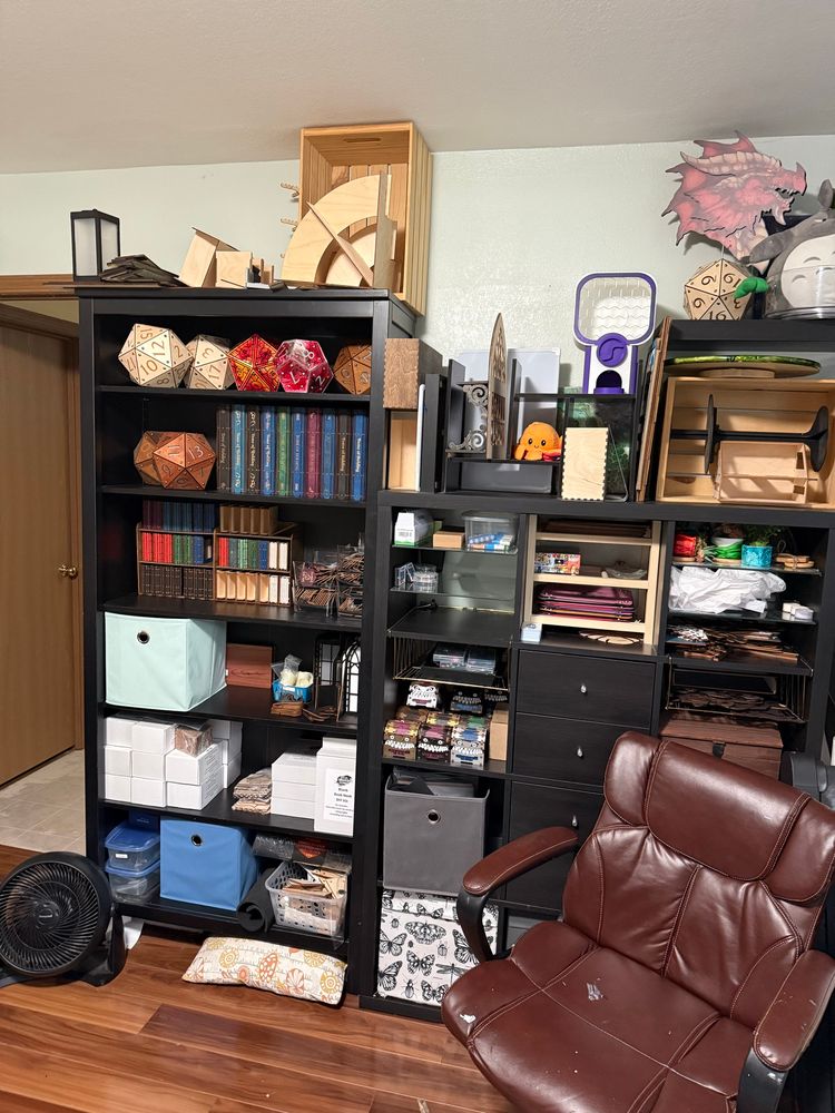 Shelves filled with nerdy products and a brown leather chair. 