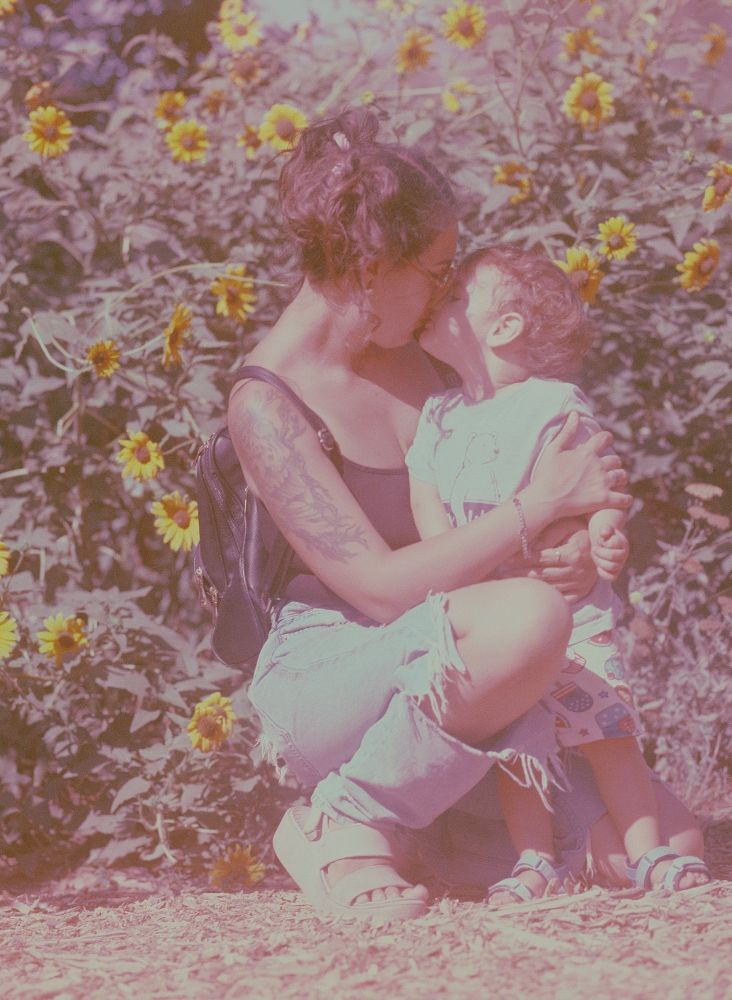 Me and Luca share a kiss in front of the sunflowers in the secret garden behind our local library 🌻