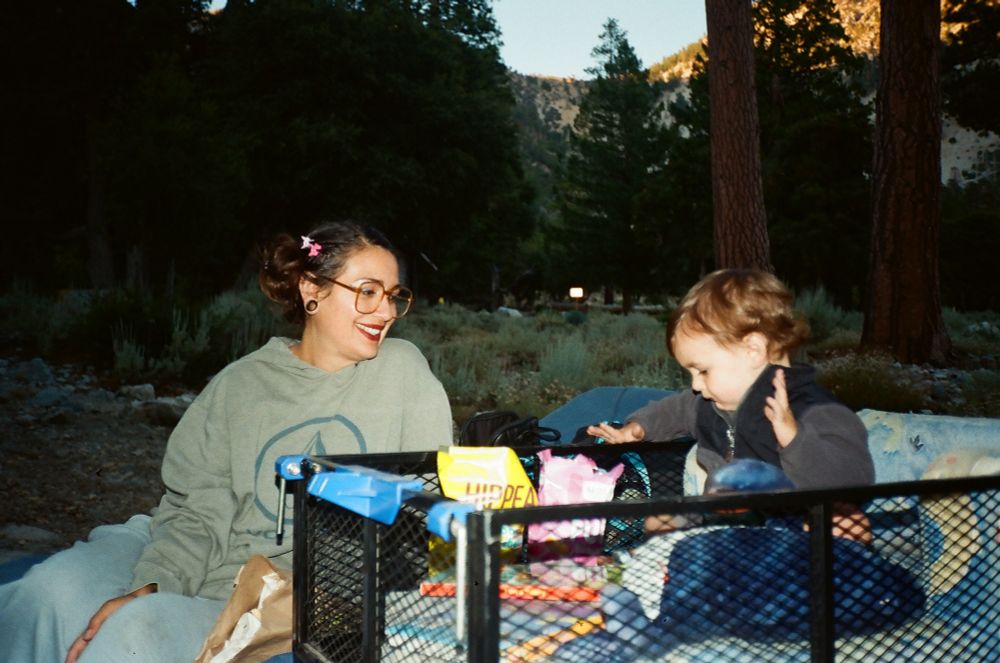 Me and Luca sitting by the fire. Luca is enjoying various snacks in his wagon
