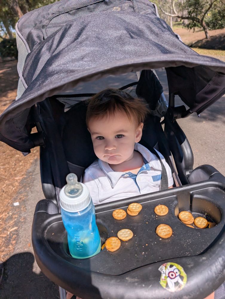 Luca with his snacks and juice. We were walking around the lake behind the library. 