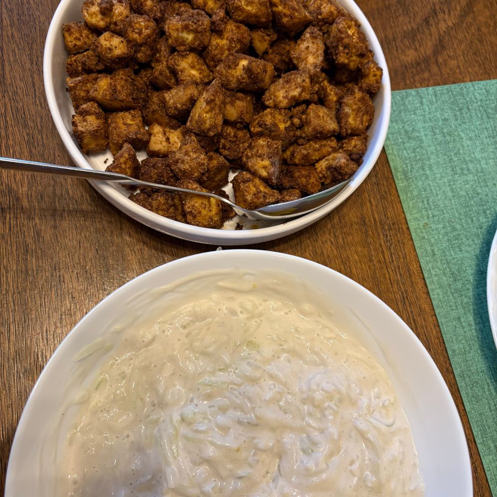 Tofu shwarma and tzaziki, in white bowls